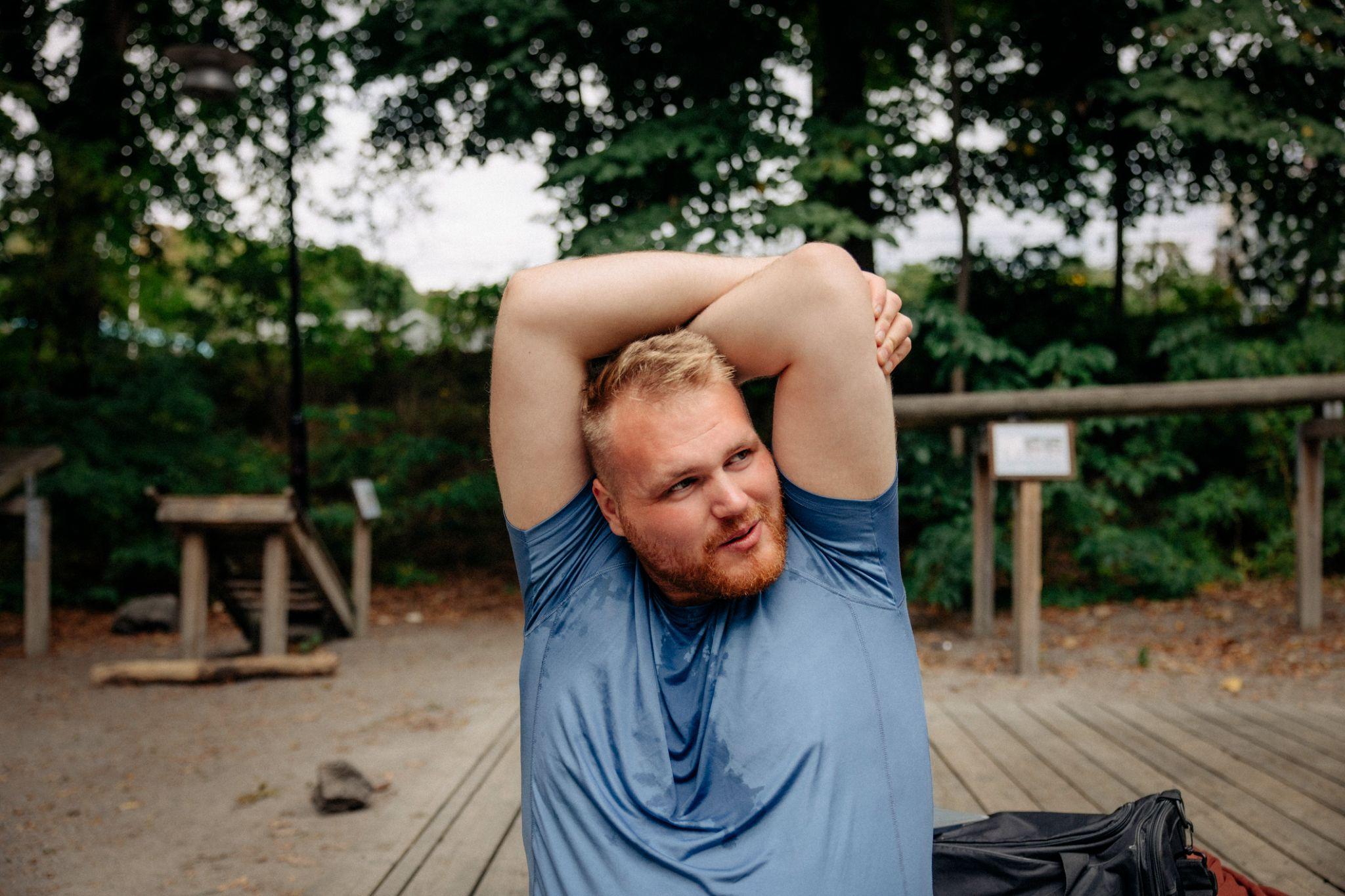 A participant stretching before a session